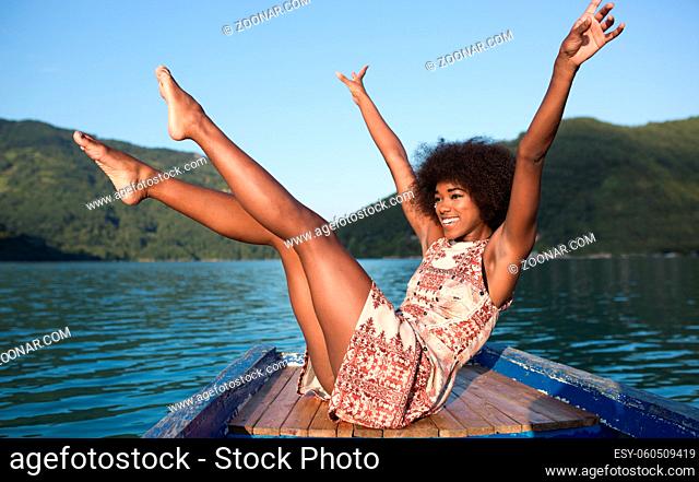 portrait of afro american woman enjoying free time on wooden boat