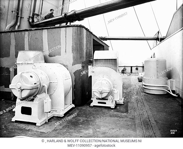 Port and starboard views of ventilating and heating fans at after end of boat deck during outfitting. Ship No: 400. Name: Olympic