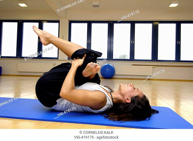 GERMANY, GEESTHACHT, 06.04.2007, Woman is making some Yoga exercises within a gym. - Geesthacht, Schleswig-Holstein, Germany, 06/04/2007