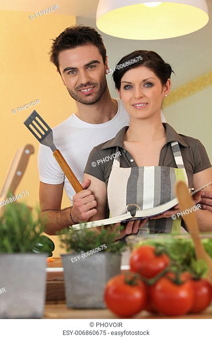 Couple in a kitchen with a cookbook