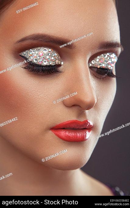 Beautiful make-up with rhinestones on the eyes
