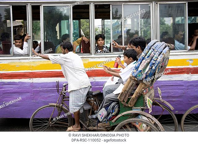 Street traffic chaos of bus and cycle rickshaw ; Dhaka ; Bangladesh