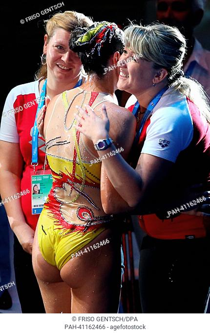 Kyra Felssner (C) of Germany gets huged by her coach Stella Mukhamedova after the Technical Solo synchronized swimming finals of the 15th FINA Swimming World...