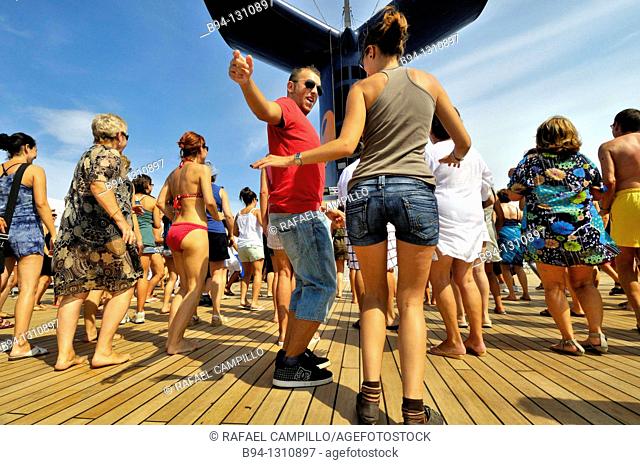 Passengers dancing on the deck of a cruise ship