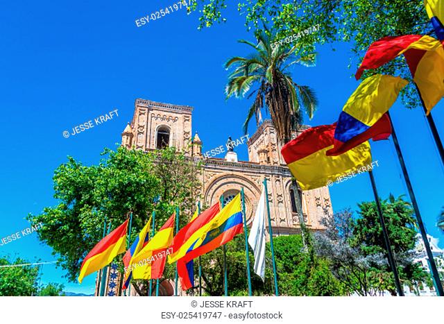 Flags waving in front of the cathedral in the historic center of Cuenca, Ecuador