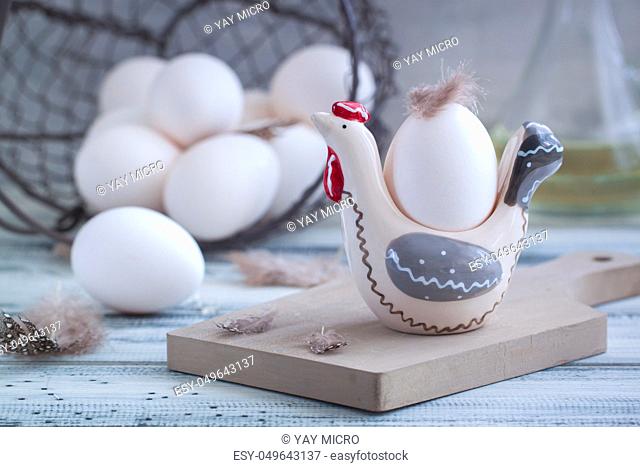 Eggs in handmade hens trays over the wooden background. Easter postcared concept. Toned