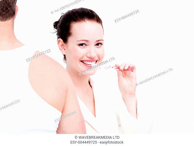 Charming couple brushing their teeths