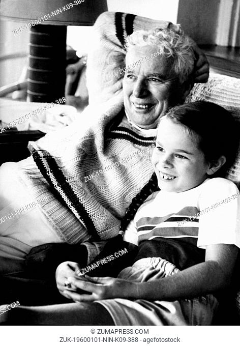 Jan. 1, 1960 - London, England, U.K. - British comedian CHARLIE CHAPLIN with daughter GERALDINE relax on the couch. Sir Charles Spencer Chaplin, Jr