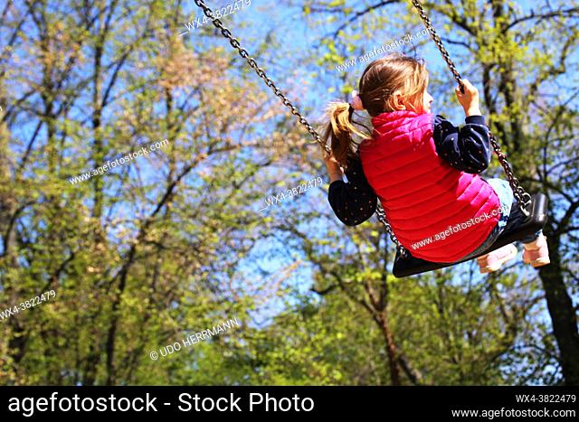 Girl swinging on a playground (model released)