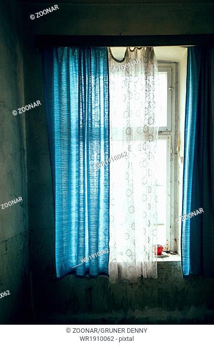 Window with blue curtain