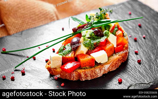 Bruschetta with roasted pumpkin, red pepper, pesto and cheese