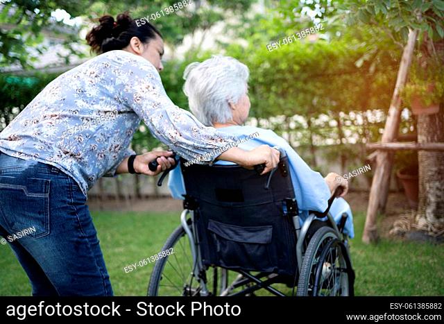 Doctor help and care Asian senior or elderly old lady woman patient sitting on wheelchair at park in nursing hospital ward, healthy strong medical concept