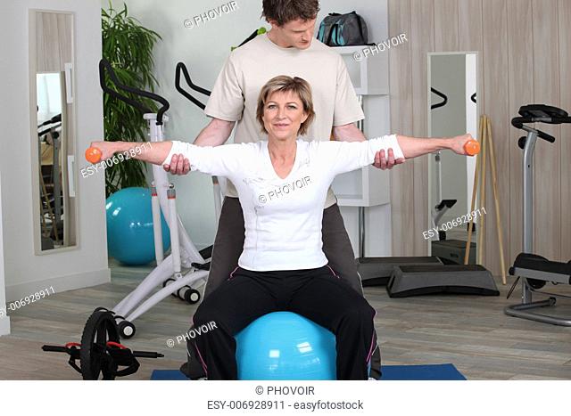 Woman in the gym with instructor