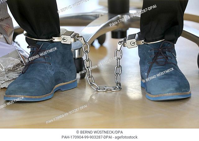 Defendant Robert K. wears shackles in the court room before the start of the trial over tax evasions running into millions at the district court in Rostock