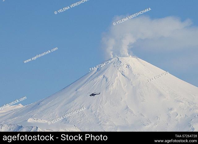 RUSSIA, KAMCHATKA REGION - FEBRUARY 9, 2023: A helicopter flies by Avachinsky active stratovolcano. Yelena Vereshchaka/TASS