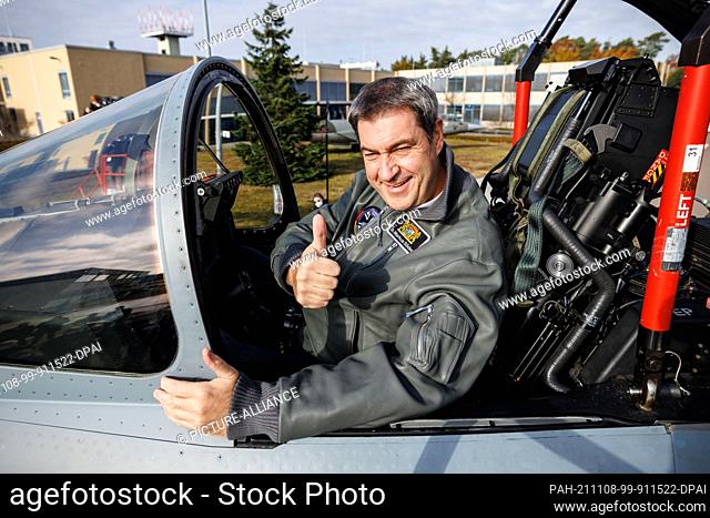 08 November 2021, Bavaria, Manching: Markus Söder, CSU party leader and Minister-President of Bavaria, sits in the cockpit of a Eurofighter multi-role fighter...