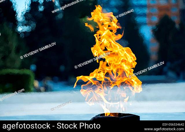 Close-up of the fire. Burning gas or gasoline burns with fire and flames. Flaming burning sparks close-up, fire patterns. Flames of fire on the street
