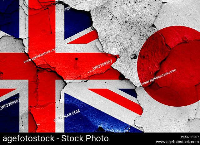 flags of UK and Japan painted on cracked wall