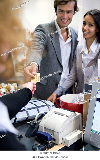 Couple paying for purchase with credit card