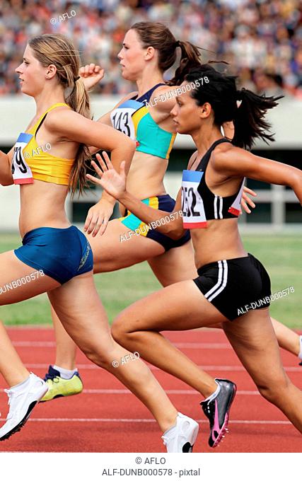Athletes running on running track