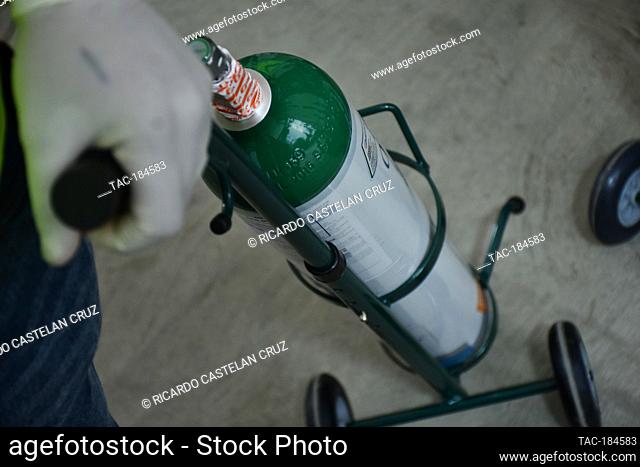 MEXICO CITY, MEXICO - JANUARY 14: A worker wears face shield while fill a oxygen tank to patients diagnosed positive with the SARS Cov-2 that causes Covid-19...