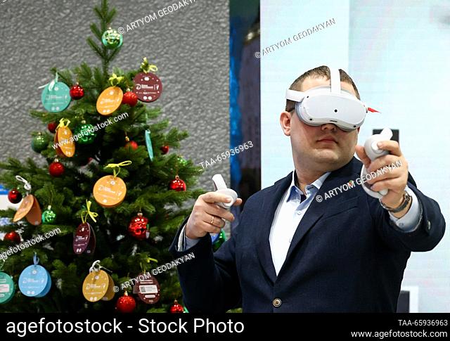 RUSSIA, MOSCOW - DECEMBER 20, 2023: A visitor tries on a VR headset at the opening of Zaporozhye Region Day during the Russia Expo international exhibition and...