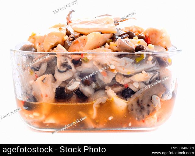 Pickled oyster mushrooms with spices in a glass bowl