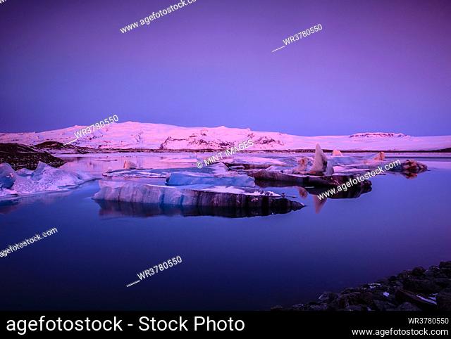 Ice floes in Iceland in pink light at dusk