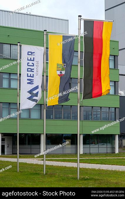 19 June 2020, Saxony-Anhalt, Arneburg: Flags of Mercer Stendal, the state of Saxony-Anhalt and the Federal Republic of Germany fly in front of the mill of the...