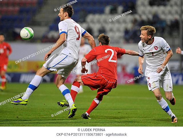 Czech Republic's Libor Kozak, left and Ladislav Krejci, right, fight for the ball with Canada's Nik Ledgerwood, center, during their friendly soccer match in...