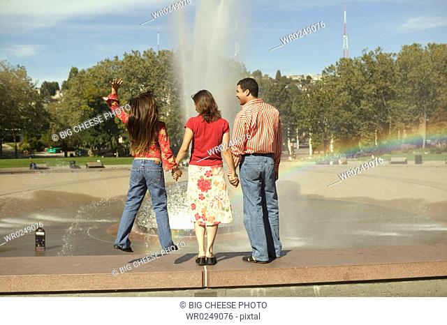 Rear view of a family watching a fountain