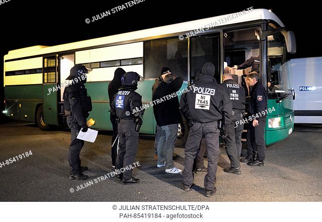 Policemen and arrested football supporters stand on a parking place in Hildesheim, Germany, 4 November 2016. The Hannoveranian police temporarily arrested...