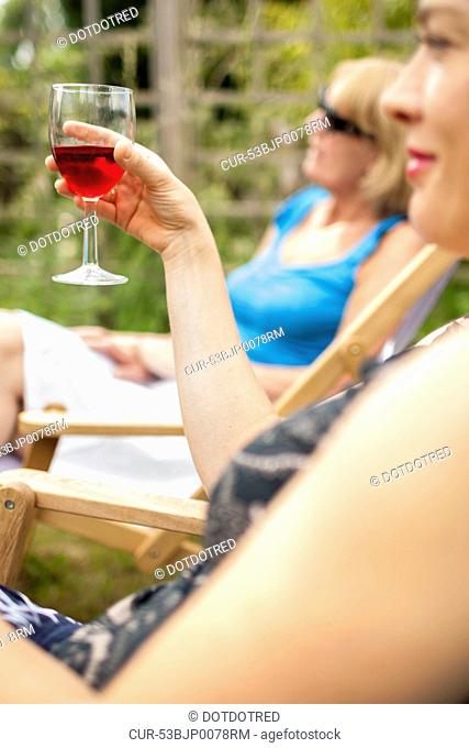 Woman having glass of wine outdoors