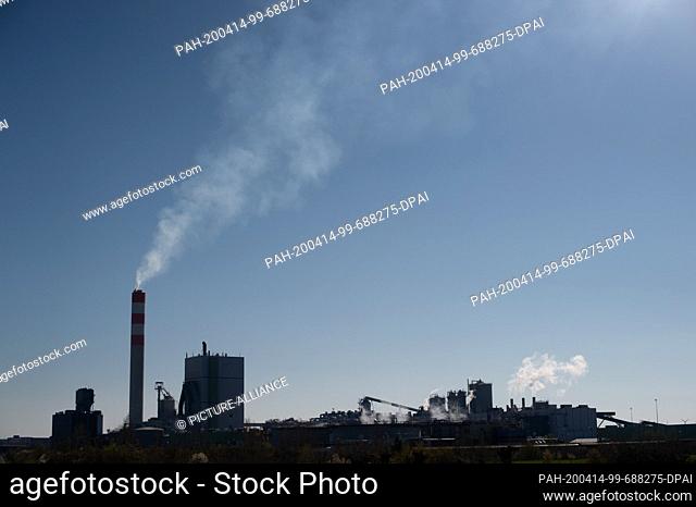 06 April 2020, Saxony-Anhalt, Anrneburg: Steam rises from chimneys of the industrial plant of the company ""Mercer Stendal""