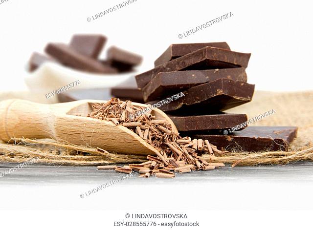 Photo of chocolate bars with cocoa in a glass with white space