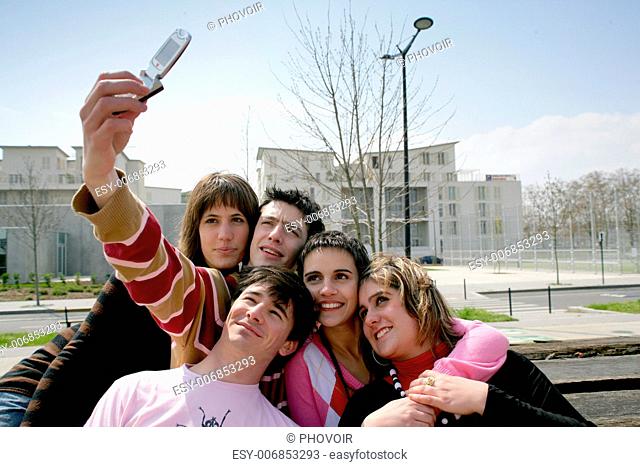 Teens taking a picture of themselves with a mobile phone