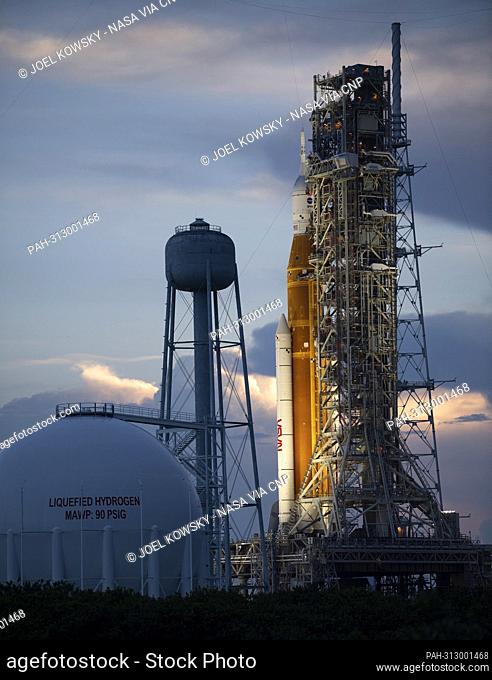 NASA’s Space Launch System (SLS) rocket with the Orion spacecraft aboard is seen at sunset atop the mobile launcher at Launch Pad 39B as preparations for launch...