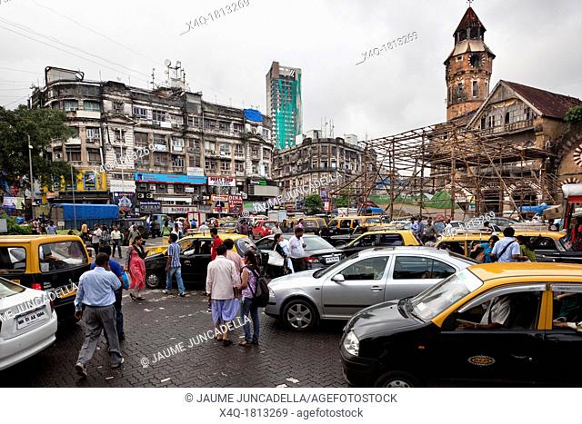 Taxis, cars, bikes and pedestrians try driving on the streets of Mumbai