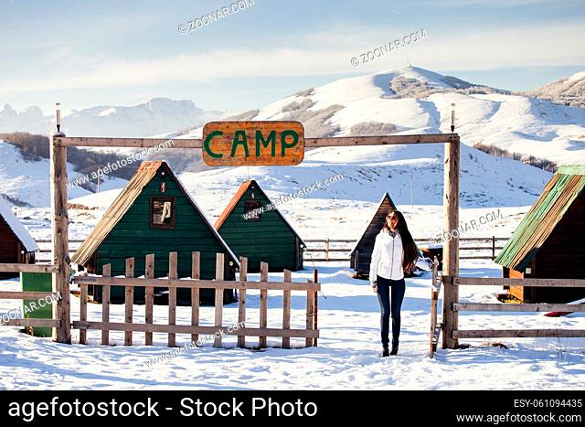 woman play with snow at ski resort camp with happy face. Winter snowy mountains background