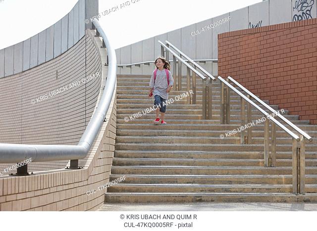 Girl climbing stairs outdoors