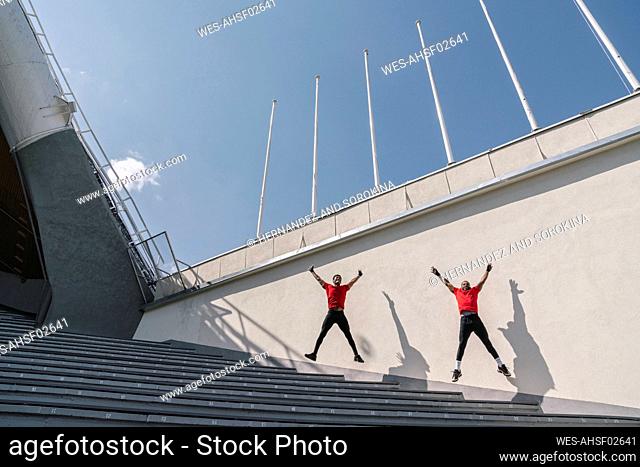 Two sportsmen jumping on stairs