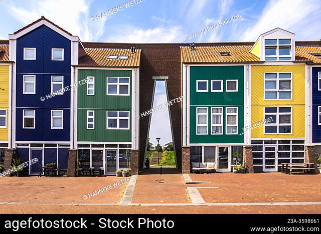 Colorful houses integrated with an old city wall in Hellevoetsluis, The Netherlands, Europe