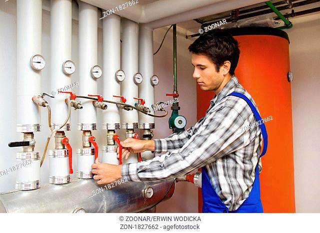 Heating engineer in the boiler room for the heating systems