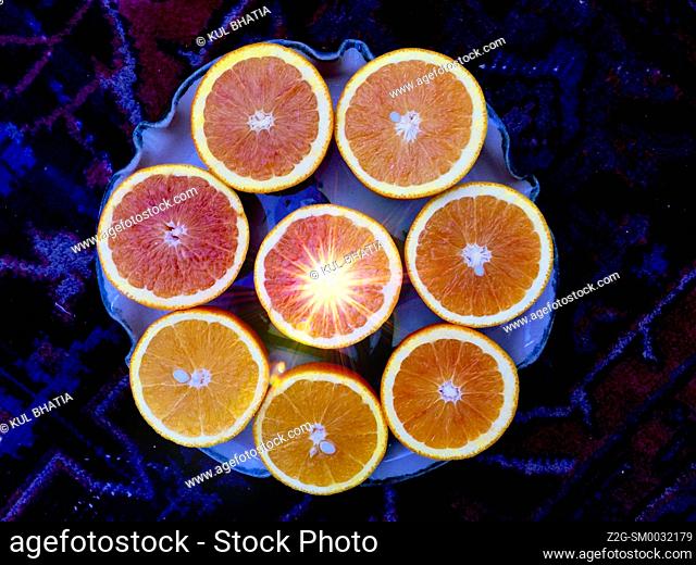 Juicy grapefruit and orange halves arrainged in a circle. Citrus fruit, rich source of Vitamin C. Concepts: tropical sunshine, cherry, optimism