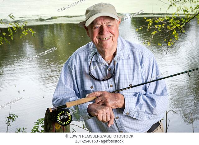 Outdoor portrait of Lefty Kreh American fly fisherman, holding his rod and reel in Timonium, Maryland, USA