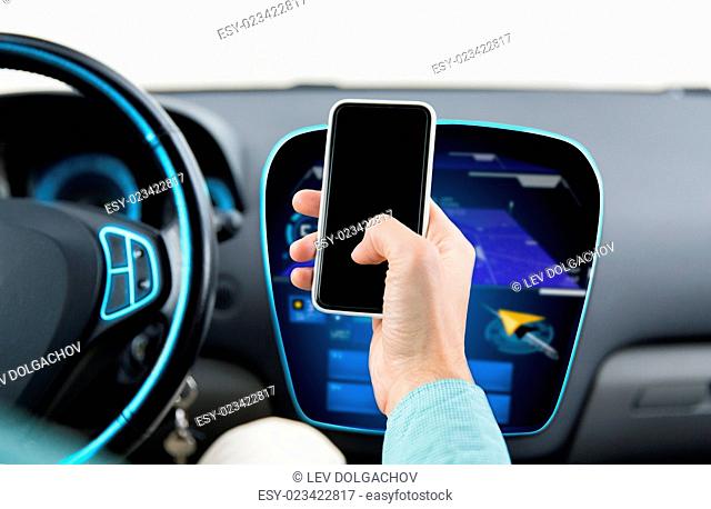 transport, business trip, technology and people concept - close up of male hand with smartphone and navigator on board computer driving car