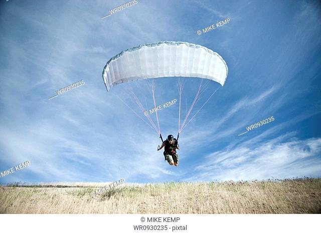 USA, Utah, Lehi, mature paraglider starting from hill