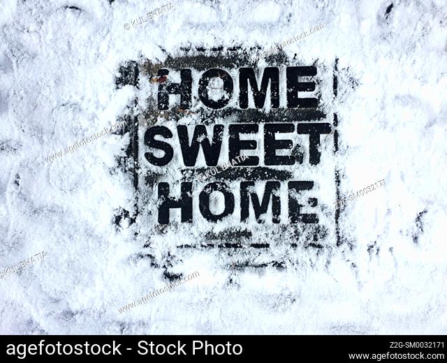 Home Sweet Home doormat in snow. Symbolic. Losing my way. Finding my way. Where is home How to reach home