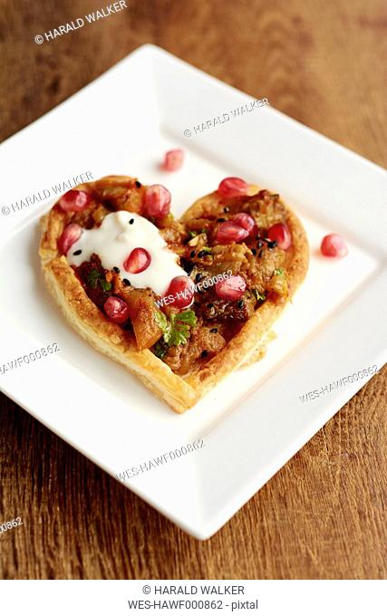 Heart shaped puff pastry tarts with eggplant and pomegranate arils