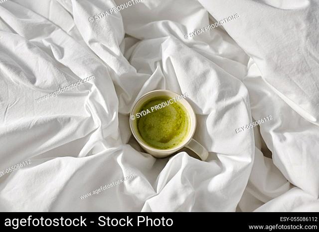 cup of matcha tea in bed at home